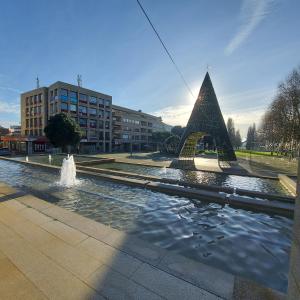 a fountain with a pyramid in the middle of a street at Alamedastudio in Vila do Conde