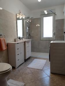 a bathroom with a toilet and a sink and a mirror at Apartment Vida in Bovec