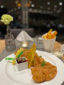 a white plate with food on a table at AiREA Hotel in Büren