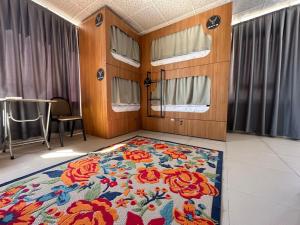 a room with a floral rug on the floor of a train at Deer Hostel & Hotel in Antalya