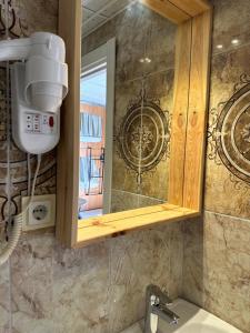 een badkamer met een wastafel, een spiegel en een douche bij Deer Hostel & Hotel in Antalya