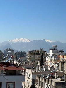 a city with buildings and mountains in the background at Deer Hostel & Hotel in Antalya