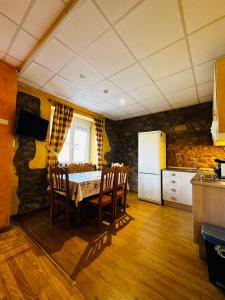 a kitchen with a table and chairs and a refrigerator at La Milana in La Robla