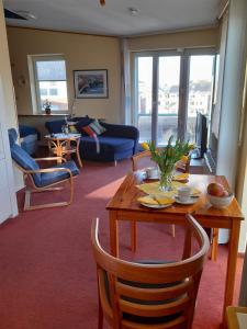 ein Wohnzimmer mit einem Tisch und einem Sofa in der Unterkunft Hafenblick-City Apartment Husum in Husum