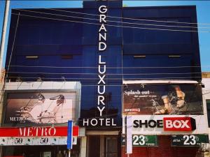 a blue building with signs on the side of it at Grand Luxury Hotel Multan in Multan