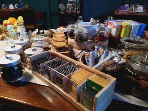 a table filled with food and jars of food at B&B Casa Caterina in Milan