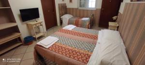 מיטה או מיטות בחדר ב-B&B San Martino