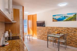 a kitchen and dining room with a table and chairs at Spacious studio next to the sea with stunning views in Santa Cruz de Tenerife