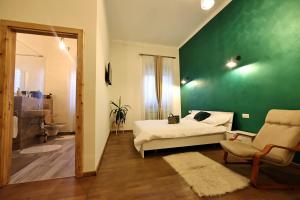 um quarto com uma cama e uma parede verde em Branko's Residence em Timisoara