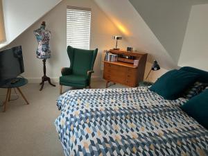 a bedroom with a bed and a desk and a chair at The Old Gin Distillery est 1850 in London