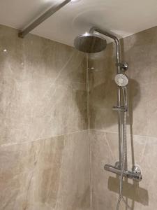 a shower with a shower head in a bathroom at Grand studio neuf à 50 m du port in Saint-Tropez