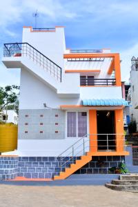 a building with an orange staircase in front of it at TGT Holidays Yercaud in Yercaud