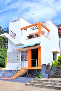 a house with orange and white at TGT Holidays Yercaud in Yercaud