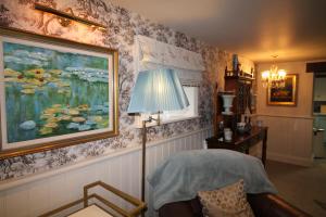 a living room with a lamp and a painting on the wall at Mr Ralphs Cottage in Whitby