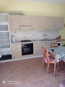 a kitchen with a table and a stove top oven at Lovely 1-Bed Apartment in Gallinaro in Gallinaro