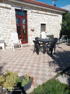 a patio with a table and chairs in front of a building at Lovely 1-Bed Apartment in Gallinaro in Gallinaro