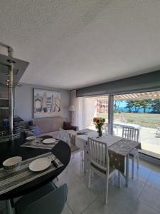 a kitchen and living room with a table and chairs at Appartement Face a la Mer in Pornic +40 photos