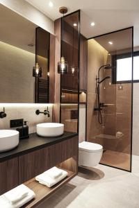a bathroom with two sinks and a shower at ZEST Residence in Kragujevac