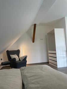 a bedroom with a bed and a chair at Boardinghouse Twistringen 