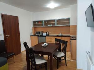 a kitchen with a table and chairs in a room at 4 Seasons 2 - Top Lodge in Bansko