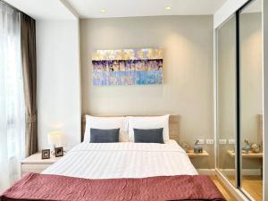 a bedroom with a large bed and a painting on the wall at Daimond Exclusive Junior Suite Bangtau Beach in Bang Tao Beach +45 photos