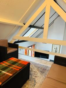 a living room with a couch and a window at Vissershuisje 6 te Koksijde in Koksijde