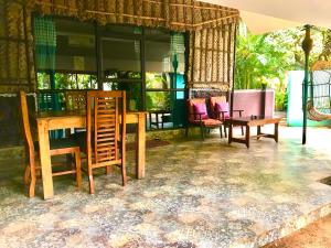 a dining room with chairs and a table and a tablektop at Marari Dreamz Homestay in Mararikulam