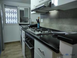 a kitchen with a stove and a counter top at mezzanine in Hammamet