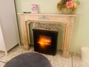 a fireplace with a fire in it in a room at Mami Guest House Rome in Rome