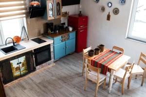 a kitchen with a table and a red refrigerator at Mieciówka in Lasowka +48 photos