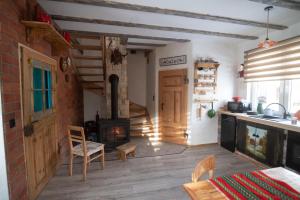 a kitchen with a wood stove in a room at Mieciówka in Lasowka