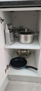 a kitchen with two pots and pans on a shelf at Marielitsa Guest Suite No 3 in Germiston