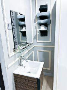 a bathroom with a sink and a mirror and towels at 61 Hotel in Gua Musang