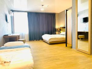 Ένα ή περισσότερα κρεβάτια σε δωμάτιο στο Green Hotel ANG