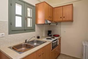 a kitchen with a sink and a stove at M. Houses 3 in Agios Romanos +13 photos