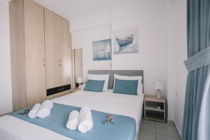 a bedroom with a bed with towels on it at Joy Apartment in Rethymno