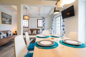 a dining room with a table with plates and wine glasses at Villa Bellevue 3 _App_ 12 in Ahlbeck