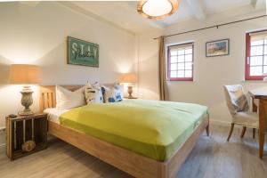 a bedroom with a large bed and a desk at Villa Bellevue 3 _App_ 12 in Ahlbeck
