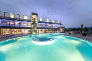 a large swimming pool in front of a building at Landhaus Piber in Piber