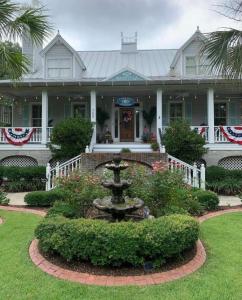 a large house with a fountain in the front yard at Caroline's Bed and Breakfast in Summerville