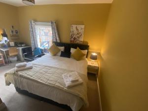 a bedroom with a bed with two towels on it at Grosvenor Place Guest House in Chester