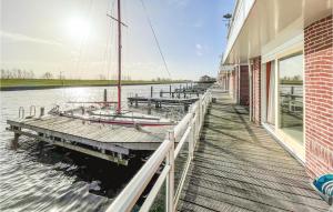 a boat is docked on a dock next to a building at Stunning Home In Workum With Kitchen in Workum