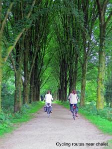 two people riding bikes down a dirt road at dutchduochalet2 in Heenweg