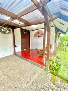 a patio of a house with awning and a bench at Fania Villa in Cinengangirang