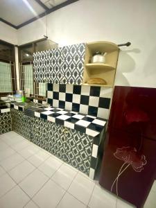 a kitchen with black and white checkered counter top at Fania Villa in Cinengangirang