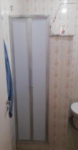 a shower door in a bathroom with a toilet at apartamento copa in Rio de Janeiro