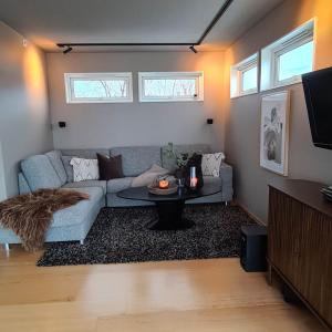 a living room with a couch and a table at Sand Beachhouse in Sand