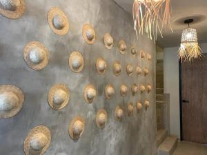 a wall with a bunch of baskets on it at Xaman - Boutique Studios in Cancún