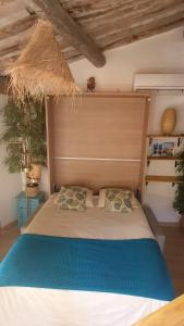 a bedroom with a large bed with a blue blanket at appartement du pêcheur à Cassis à 10 mètres du port in Cassis