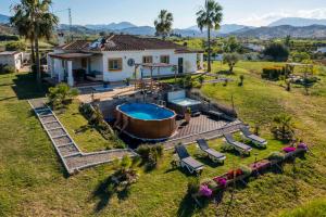 an aerial view of a house with a swimming pool at Casa de los Sueños in Coín
